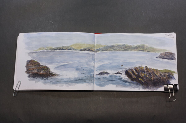 Third attempt at a watercolor of a gloomy Shetland seaside picture I found in a Shetland knits book. This one done in a watercolor book and spans both the left and right pages. Still didn't capture the gloomy overcast scene. I did get to use a new lavender color for the sky in all versions, which was fun.