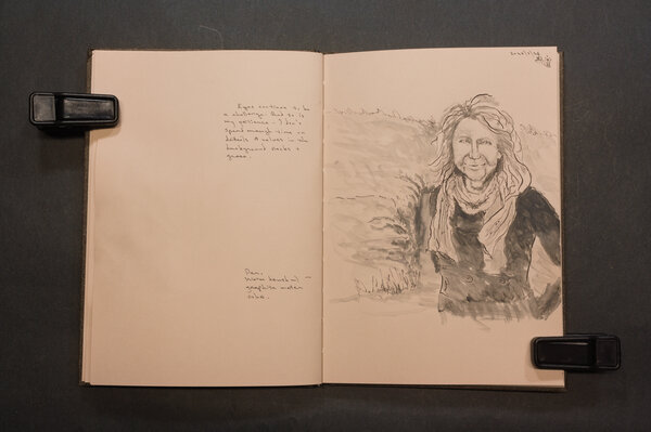 Older woman with knitted scarf by a Scottish rocky and grassy hill, pen and dark graphite watercolor wash.